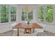 Charming dining nook with abundant natural light through multiple windows at 1318 Indian Camp Rd, Chapel Hill, NC 27516