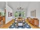 Bright dining room featuring hardwood floors, modern lighting, and large windows for natural light at 1318 Indian Camp Rd, Chapel Hill, NC 27516