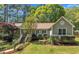 Well-maintained home with manicured landscaping, mature trees, and beautiful green lawn under a blue sky at 1318 Indian Camp Rd, Chapel Hill, NC 27516