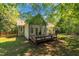 Rear exterior of a house showing a wooden deck, set amongst the trees at 1318 Indian Camp Rd, Chapel Hill, NC 27516