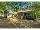 Home exterior featuring a covered patio, deck, and a well-maintained yard at 1318 Indian Camp Rd, Chapel Hill, NC 27516