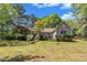 Inviting one-story home with manicured lawn, mature trees, and charming landscaping at 1318 Indian Camp Rd, Chapel Hill, NC 27516