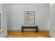 Minimalist hallway with hardwood floors, modern art, bench, and ample natural light at 1318 Indian Camp Rd, Chapel Hill, NC 27516
