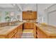 Bright kitchen with custom wood cabinets, tiled countertops, and stainless steel appliances at 1318 Indian Camp Rd, Chapel Hill, NC 27516