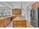 Well-lit kitchen boasts custom cabinets, tile countertops, and modern stainless steel appliances at 1318 Indian Camp Rd, Chapel Hill, NC 27516