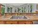 Kitchen sink surrounded by bright windows and a tiled counter, offering ample natural light at 1318 Indian Camp Rd, Chapel Hill, NC 27516