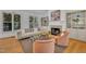 Inviting living room with fireplace, built-in shelving, comfortable seating, and scenic outdoor views at 1318 Indian Camp Rd, Chapel Hill, NC 27516