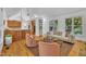 Open-concept living area with hardwood floors, comfortable seating, and seamless access to the kitchen at 1318 Indian Camp Rd, Chapel Hill, NC 27516