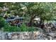 Outdoor dining area with ample seating under lush trees, creating a serene atmosphere at 1318 Indian Camp Rd, Chapel Hill, NC 27516