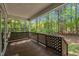 Cozy covered porch featuring lattice railing with views of the lush surrounding greenery at 1318 Indian Camp Rd, Chapel Hill, NC 27516