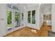 Bright sunroom with hardwood floors and large windows offering scenic views of the outdoors at 1318 Indian Camp Rd, Chapel Hill, NC 27516