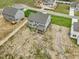 Drone shot of a gray home with a screened in porch in a neighborhood at 138 Alden Way, Angier, NC 27501
