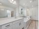 Primary bathroom showcasing dual vanities, a soaking tub, and a glass-enclosed shower at 138 Alden Way, Angier, NC 27501