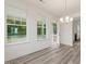 Open dining area featuring three windows with backyard views and a modern chandelier above the dining space at 138 Alden Way, Angier, NC 27501