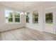 Bright dining area with multiple windows and a door, offering ample natural light and access to the outdoors at 138 Alden Way, Angier, NC 27501