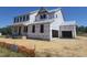 Two-story home under construction featuring an attached two-car garage, and a covered porch at 138 Alden Way, Angier, NC 27501