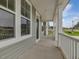 Covered front porch featuring white columns, gray siding, and a welcoming entrance at 138 Alden Way, Angier, NC 27501