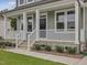 Inviting front porch with white railings, gray siding, and a well-maintained yard at 138 Alden Way, Angier, NC 27501