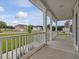 View of the long porch with a green yard and neighborhood in the distance at 138 Alden Way, Angier, NC 27501