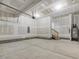 Large unfinished garage with concrete floors, a water heater, and unfinished drywall at 138 Alden Way, Angier, NC 27501