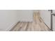 Hallway with neutral walls and laminate flooring, doors accessing different rooms at 138 Alden Way, Angier, NC 27501
