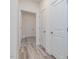 Hallway with neutral walls and laminate flooring, doors accessing different rooms at 138 Alden Way, Angier, NC 27501