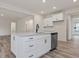 Kitchen island featuring white cabinetry, black hardware and modern faucet at 138 Alden Way, Angier, NC 27501