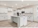 Bright kitchen with white cabinets, large center island and stainless steel appliances at 138 Alden Way, Angier, NC 27501