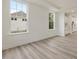 Living room with views from windows and light wood flooring at 138 Alden Way, Angier, NC 27501