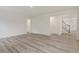 A bright open-concept living area with clean lines and modern finishes, with a glimpse of the staircase at 138 Alden Way, Angier, NC 27501