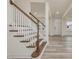 Staircase with wood steps and white risers, and a view of the entry door at 138 Alden Way, Angier, NC 27501