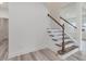 Staircase with wooden treads and white risers, showcasing a modern design and natural light at 138 Alden Way, Angier, NC 27501
