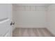 Walk-in closet featuring wire shelving and neutral carpet, offering ample storage space at 138 Alden Way, Angier, NC 27501
