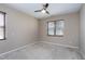 This carpeted bedroom features a ceiling fan and window with wood-look blinds at 138 Horizon Trl, Garner, NC 27529