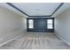 Neutral bedroom featuring a tray ceiling, carpet floors, and natural light at 138 Horizon Trl, Garner, NC 27529