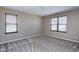 This bedroom is carpeted and has two windows with wood-look blinds at 138 Horizon Trl, Garner, NC 27529