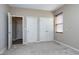 This bedroom has multiple doors and a window with wood-look blinds at 138 Horizon Trl, Garner, NC 27529