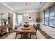 Bright dining room features hardwood floors, neutral paint, a decorative chandelier, and large windows at 138 Horizon Trl, Garner, NC 27529