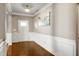 Inviting foyer with hardwood floors, white wainscoting, and a bright white front door at 138 Horizon Trl, Garner, NC 27529
