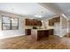 Open kitchen with wood cabinets, granite counters, stainless appliances, and island with sink at 138 Horizon Trl, Garner, NC 27529