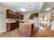 Spacious kitchen with a center island, dark wood cabinets, granite countertops, and stainless appliances at 138 Horizon Trl, Garner, NC 27529
