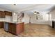 Modern kitchen with an island and granite countertops, flowing into an open-concept living space at 138 Horizon Trl, Garner, NC 27529