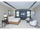 Staged primary bedroom featuring a tray ceiling, natural light, and neutral colors at 138 Horizon Trl, Garner, NC 27529