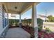 Covered porch with stone pillars, providing a welcoming outdoor space with manicured shrubs at 138 Horizon Trl, Garner, NC 27529