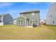 Large backyard with green lawn, patio, and the back exterior of the home at 1501 Addison Lake St, Fuquay Varina, NC 27526