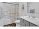 Modern bathroom with a shower-tub combo and stylish grey vanity with countertop at 1501 Addison Lake St, Fuquay Varina, NC 27526