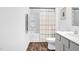 A clean bathroom featuring shower-tub combo, gray vanity and modern fixtures at 1501 Addison Lake St, Fuquay Varina, NC 27526