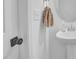 Simple bathroom featuring a pedestal sink with decorative mirror and towel, and a light fixture at 1501 Addison Lake St, Fuquay Varina, NC 27526