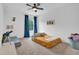 Bright bedroom with carpet, ceiling fan, decor, and a window with blue curtains at 1501 Addison Lake St, Fuquay Varina, NC 27526