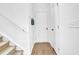 Clean and bright entryway featuring wood-look flooring, coat closet and access to upper level at 1501 Addison Lake St, Fuquay Varina, NC 27526